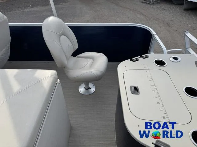 Slide: The Image of 2017 Bennington 21SSX Pontoon interior with seating and control panel, Boat World logo visible. - 33