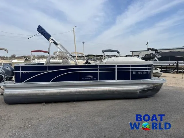 Slide: The Image of 2017 Bennington 21SSX Pontoon boat in a marina setting. - 42