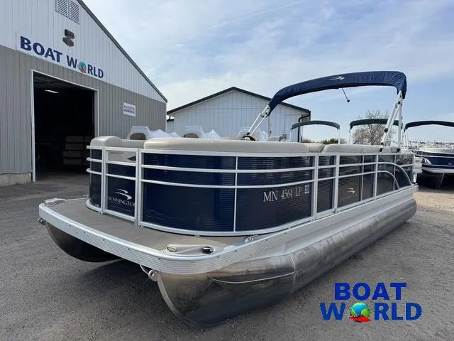 Slide: The Image of 2017 Bennington 21SSX Pontoon boat at Boat World dealership, featuring sleek design and blue canopy. - 45