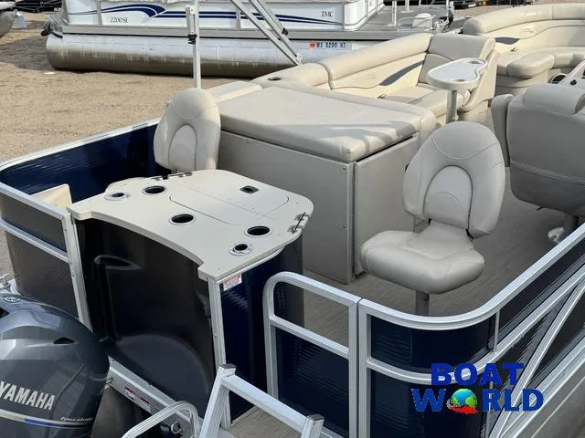 Slide: The Image of 2017 Bennington 21SSX Pontoon boat with Yamaha motor, featuring comfortable seating and cup holders. - 7