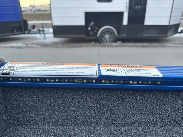 Slide: The Image of 2024 Lund 1650 Angler Sport boat interior with warning labels and LED lights. - 10