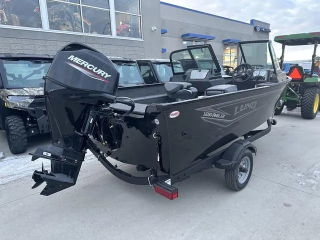 Slide: The Image of 2024 Lund 1650 Angler Sport boat with Mercury engine, parked outdoors. - 3