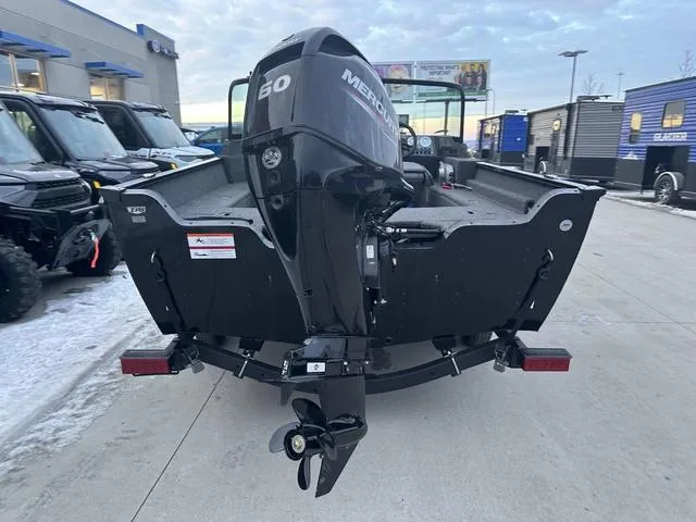 Slide: The Image of 2024 Lund 1650 Angler Sport boat with Mercury 60 engine, parked outdoors. - 4