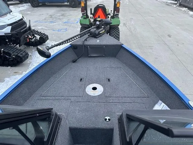 Slide: The Image of 2024 Lund 1650 Angler Sport boat interior with trolling motor on a snowy day. - 6