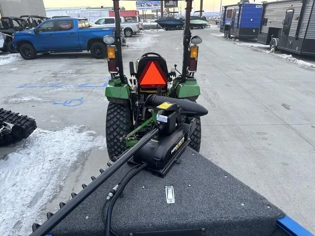 Slide: The Image of 2024 Lund 1650 Angler Sport boat with a PowerDrive motor in a snowy parking lot. - 7