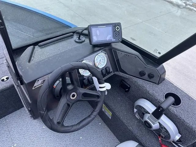 Slide: The Image of 2024 Lund 1650 Angler Sport dashboard with steering wheel and navigation system. - 8