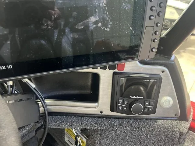 Slide: The Image of Control panel of 2024 Lund 2025 Impact XS Sport boat with electronic display and audio system. - 13