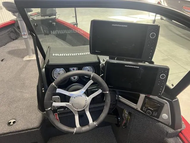 Slide: The Image of 2024 Lund 2025 Impact XS Sport boat dashboard with Humminbird electronics and steering wheel. - 15