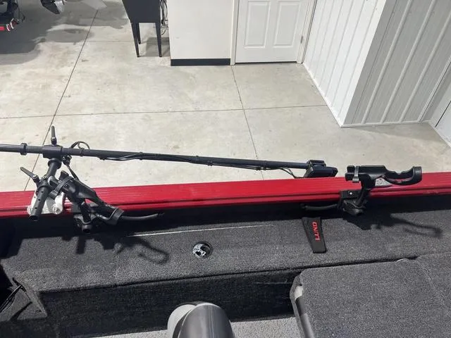 Slide: The Image of 2024 Lund 2025 Impact XS Sport boat interior with fishing rod holder. - 19