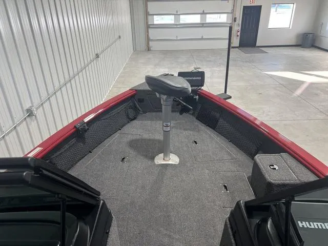 Slide: The Image of 2024 Lund 2025 Impact XS Sport boat interior with fishing seat and equipment. - 6