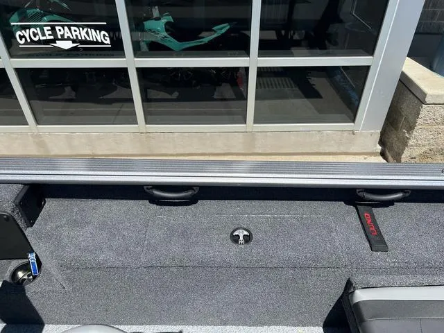 Slide: The Image of 2024 Lund 2025 Impact XS Sport boat interior near cycle parking area. - 13