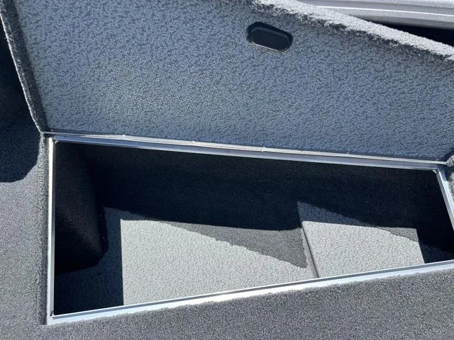 Slide: The Image of 2024 Lund 2025 Impact XS Sport boat storage compartment, open and empty. - 22
