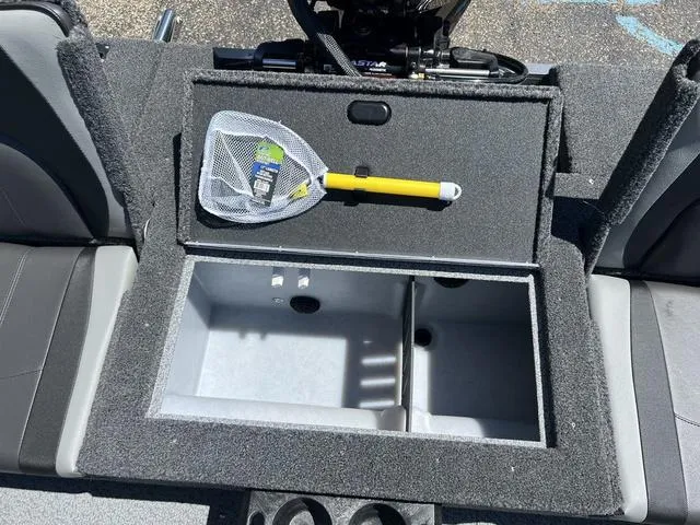 Slide: The Image of 2024 Lund 2025 Impact XS Sport boat interior with storage compartment and fishing net. - 24