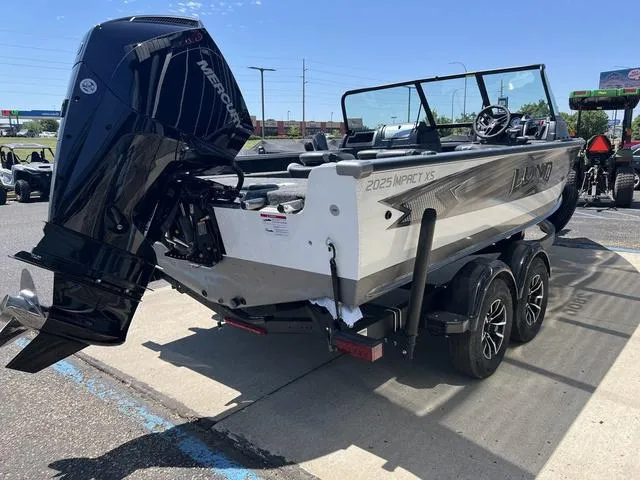 Slide: The Image of 2024 Lund 2025 Impact XS Sport boat on trailer, featuring a powerful Mercury outboard engine. - 3
