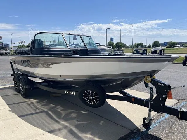 Slide: The Image of 2024 Lund 2025 Impact XS Sport boat on trailer, parked outdoors. - 4