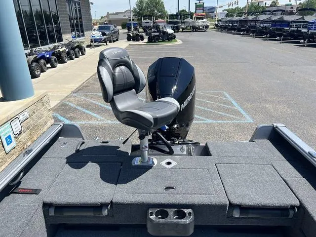 Slide: The Image of 2024 Lund 2025 Impact XS Sport boat with Mercury engine in parking lot. - 6