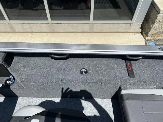 Slide: The Image of 2024 Lund 2025 Impact XS Sport boat interior with seating and storage compartments. - 8