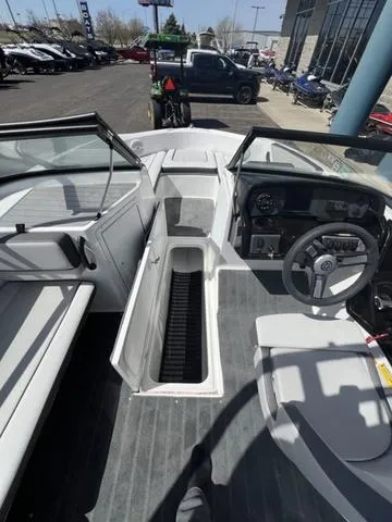 Slide: The Image of 2024 Yamaha Boats AR190 interior with steering wheel, seating, and storage compartment. - 14