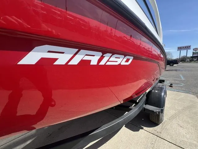 Slide: The Image of 2024 Yamaha Boats AR190 in vibrant red on a trailer, side view. - 5
