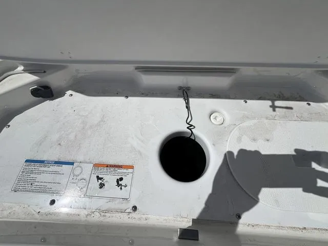 Slide: The Image of 2024 Yamaha Boats AR190 deck with storage compartment and safety instructions. - 8