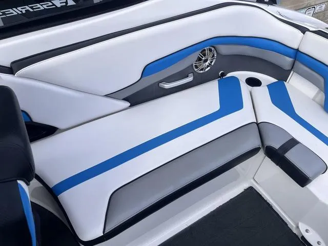 Slide: The Image of 2016 Yamaha Boats 242X E-Series interior with blue and white seating and speaker detail. - 26