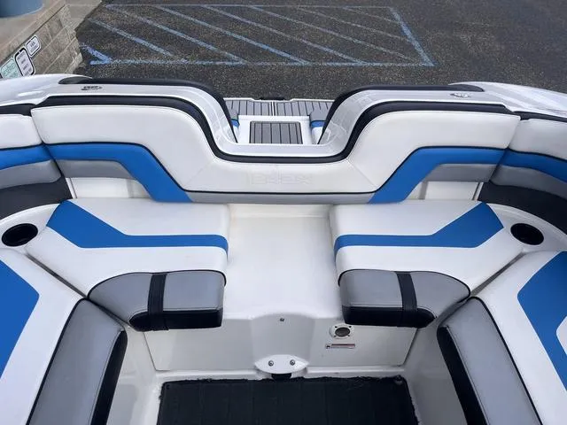 Slide: The Image of 2016 Yamaha Boats 242X E-Series interior with blue and white seating, rear view. - 27