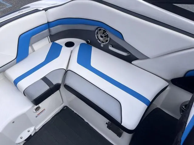 Slide: The Image of 2016 Yamaha Boats 242X E-Series interior with blue and white seating and speaker detail. - 28
