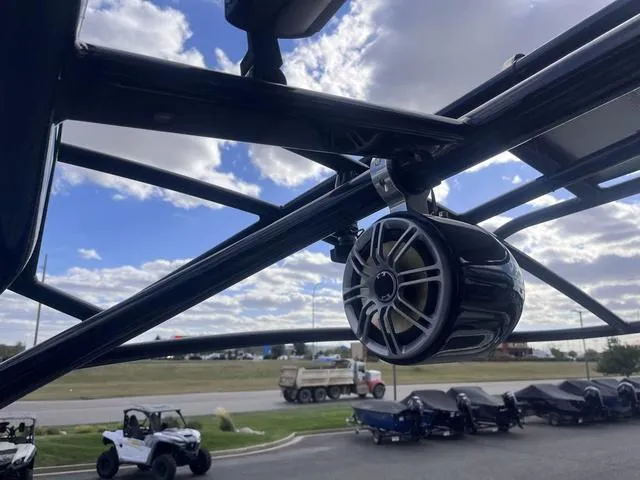 Slide: The Image of Speaker on Yamaha Boats 242X E-Series, 2016 model, with a scenic outdoor background. - 30