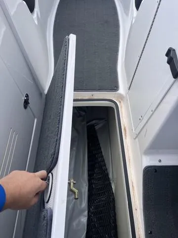 Slide: The Image of 2016 Yamaha Boats 242X E-Series storage compartment with open hatch. - 38