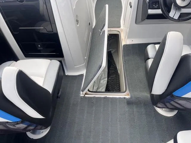 Slide: The Image of 2016 Yamaha Boats 242X E-Series interior with open storage compartment and seating. - 39