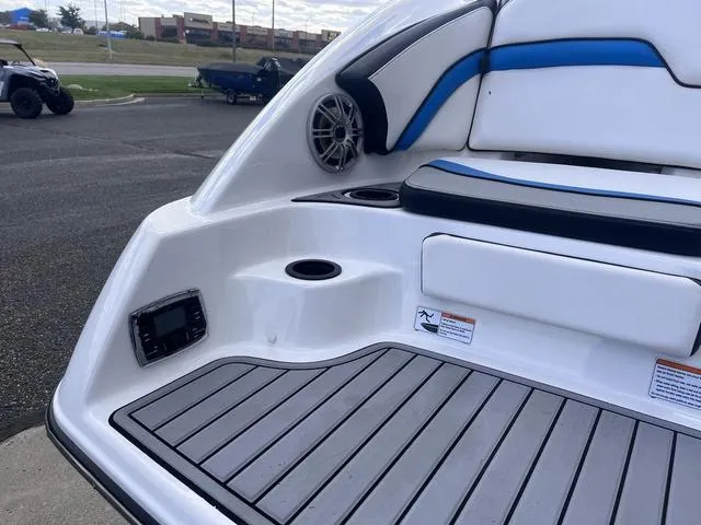 Slide: The Image of 2016 Yamaha Boats 242X E-Series interior with speaker, cup holder, and cushioned seating. - 7