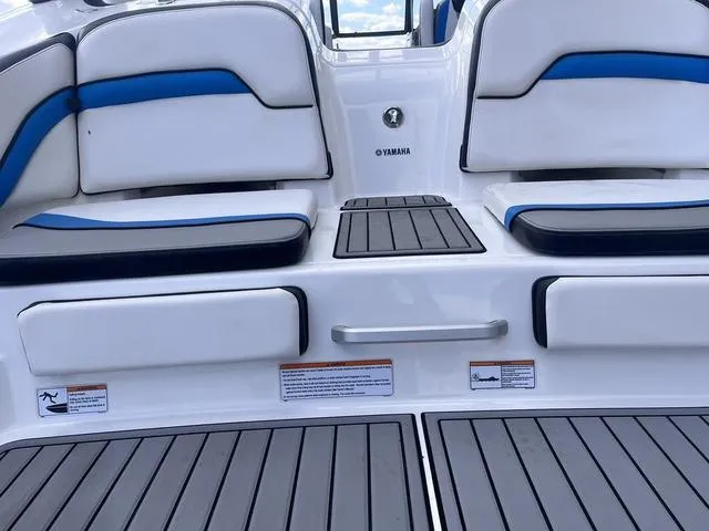 Slide: The Image of 2016 Yamaha Boats 242X E-Series interior with white and blue seating, non-slip flooring. - 8