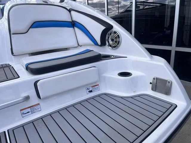 Slide: The Image of 2016 Yamaha Boats 242X E-Series interior with cushioned seating and speaker detail. - 9