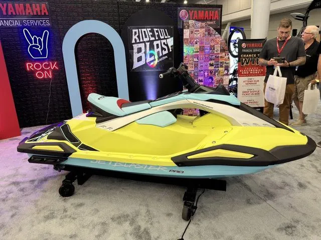 Slide: The Image of 2025 Yamaha WaveRunner JetBlaster Pro 3-Up displayed at an event, vibrant yellow and blue design. - 11