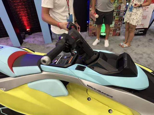 Slide: The Image of 2025 Yamaha WaveRunner JetBlaster Pro 3-Up with vibrant design on display at an event. - 16