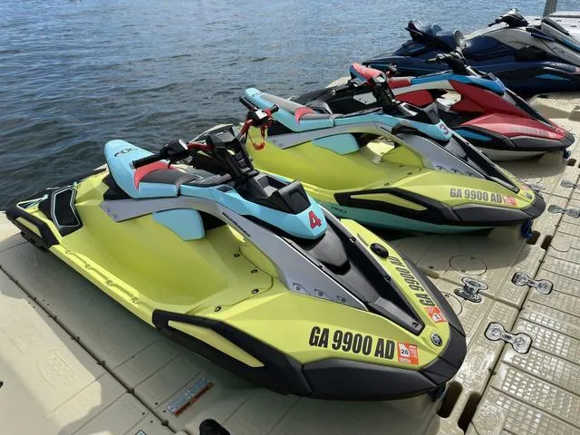 Slide: The Image of 2025 Yamaha WaveRunner JetBlaster Pro 3-Up jet skis docked by the water. - 37