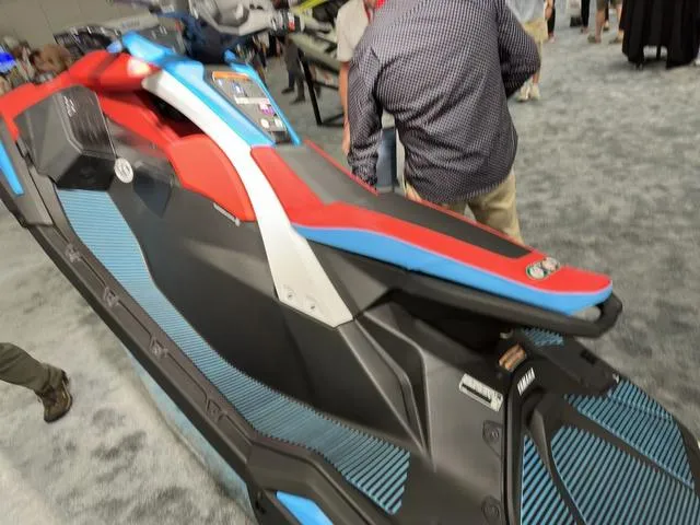 Slide: The Image of 2025 Yamaha WaveRunner Jetblaster in vibrant red and blue on display indoors. - 6