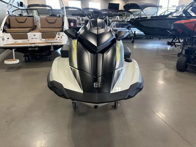 Slide: The Image of 2025 Yamaha Waverunner GP jet ski displayed in a showroom with other boats. - 2