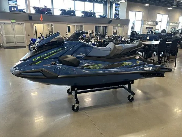 Slide: The Image of 2025 Yamaha Waverunner VX Cruiser HO in showroom, sleek design, blue color, displayed on stand. - 1