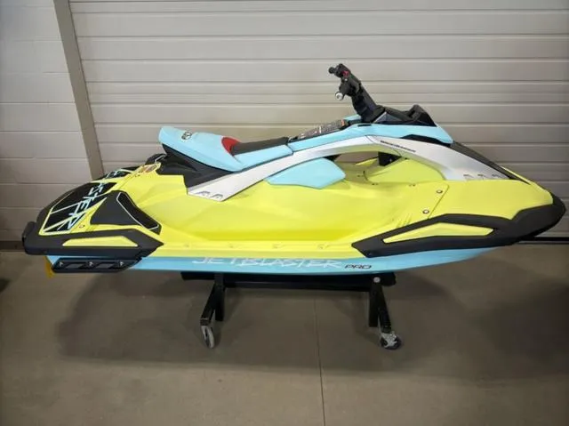 Slide: The Image of 2025 Yamaha Waverunner Jetblaster in vibrant yellow and blue, displayed indoors. - 1