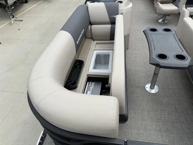 Slide: The Image of 2024 Bennington 22 SSR Tri-Toon Pontoon with beige seating and built-in storage. - 10
