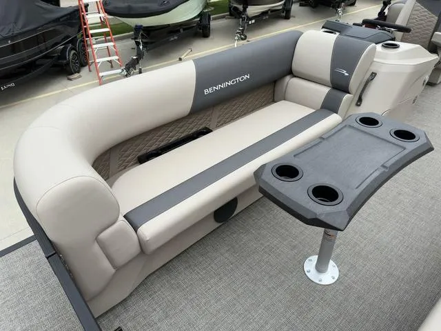 Slide: The Image of 2024 Bennington 22 SSR Tri-Toon Pontoon with plush seating and cupholder table. - 14