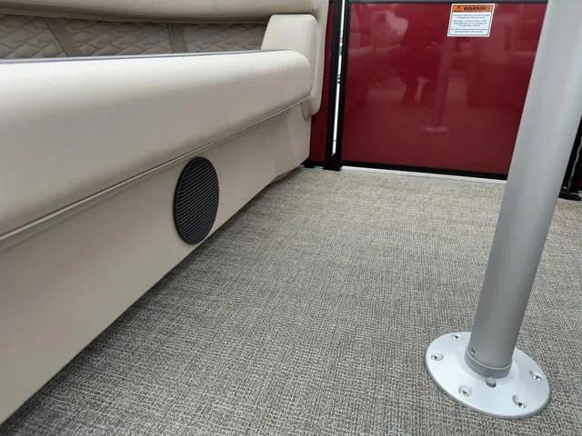 Slide: The Image of 2024 Bennington 22 SSR Tri-Toon Pontoon interior with beige seating and carpeted flooring. - 15