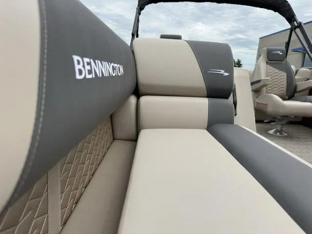 Slide: The Image of 2024 Bennington 22 SSR Tri-Toon Pontoon, featuring luxurious beige and gray seating. - 16