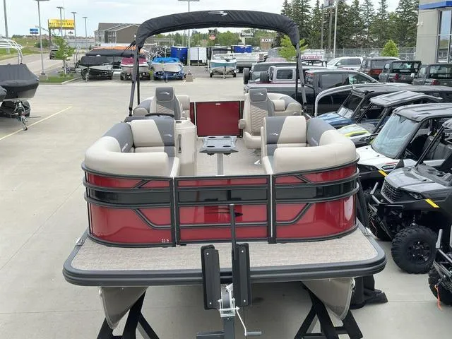 Slide: The Image of 2024 Bennington 22 SSR Tri-Toon Pontoon, red exterior, spacious seating, displayed in a dealership lot. - 2