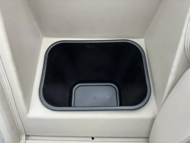 Slide: The Image of 2024 Bennington 22 SSR Tri-Toon Pontoon storage compartment, black interior, beige exterior. - 22