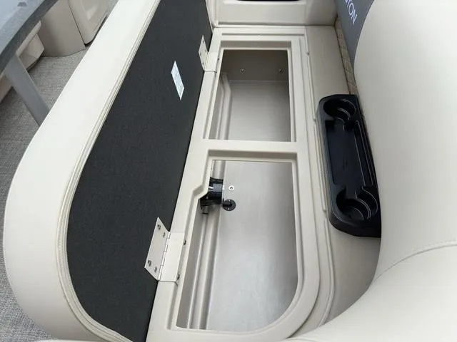 Slide: The Image of 2024 Bennington 22 SSR Tri-Toon Pontoon storage compartment with cup holders and seating. - 23