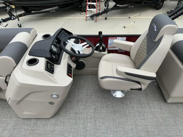 Slide: The Image of 2024 Bennington 22 SSR Tri-Toon Pontoon helm with steering wheel and captain's chair. - 26