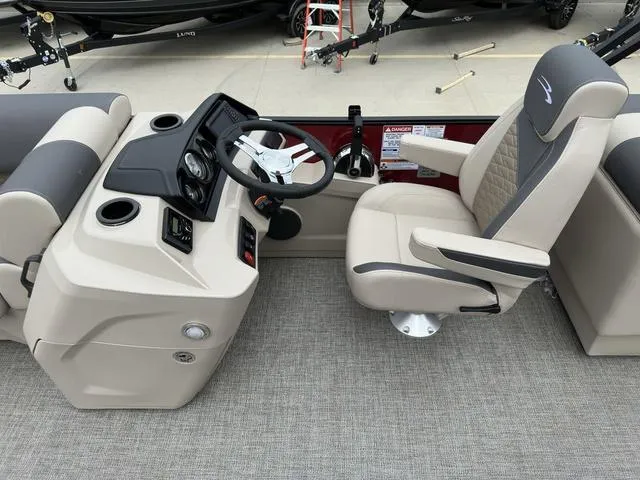 Slide: The Image of 2024 Bennington 22 SSR Tri-Toon Pontoon helm with steering wheel and captain's chair. - 31