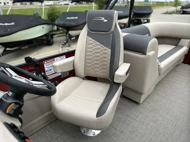 Slide: The Image of 2024 Bennington 22 SSR Tri-Toon Pontoon captain's chair and seating area. - 32